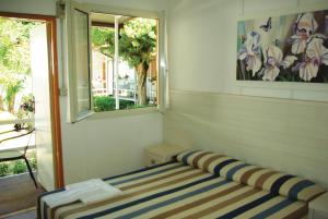 Postel nebo postele na pokoji v ubytování Villaggio Benvivere