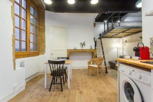 a kitchen with a table and chairs in a room at Le Vieux Lyon charmant et authentique in Lyon
