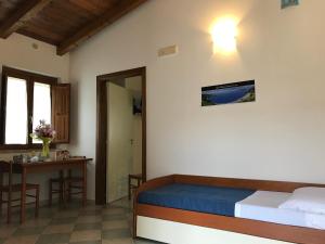 A bed or beds in a room at Arcomagno Beach Resort