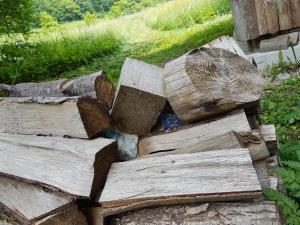 a pile of wood sitting on the ground at Eko House Dobrenica in Bihać