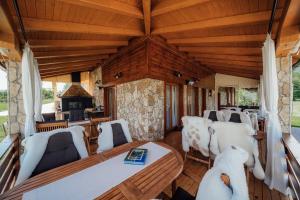 a living room with white chairs and a wooden ceiling at B&B Plitvice Lakes Villa Irene in Plitvička Jezera