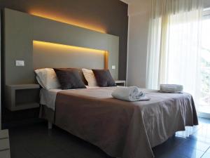 a bedroom with a large bed with a head board at Hotel Desire' in Riccione