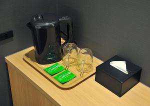 a coffee maker and two wine glasses on a counter at FUGASTAY Shijo Omiya in Kyoto