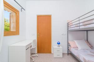 A bed or beds in a room at Es Pont Den Teulari Nou