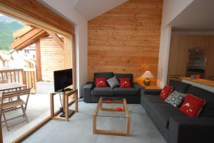 uma sala de estar com um sofá e uma mesa em Les Sept Étoiles em Le Monêtier-les-Bains