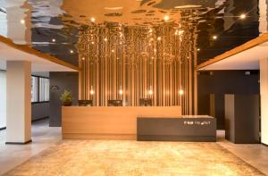 a lobby with a large gold chandelier on the ceiling at Hotel Cap Negret in Altea
