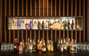 a bar with a lot of bottles of alcohol at Hotel Cap Negret in Altea