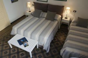 a bedroom with a bed and a table with a book at B&B Casa Laganà in Reggio di Calabria