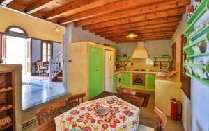 a kitchen with a table and a green refrigerator at Villa Pera Meria in Meyisti