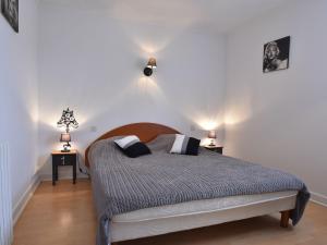 a bedroom with a bed and two night stands at Modern holiday home in Besse with private pool in Villefranche-du-Périgord