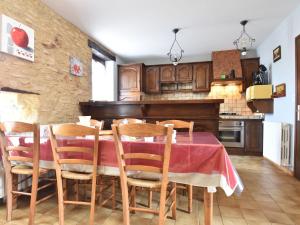 a kitchen with a table with chairs and a piano at Modern holiday home in Besse with private pool in Villefranche-du-Périgord