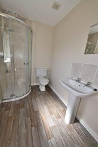 a bathroom with a shower and a sink and a toilet at Knocklea in Alness