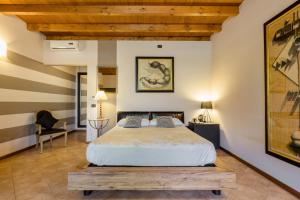 1 dormitorio con 1 cama grande y techo de madera en Agriturismo Moscatello, en Pozzolengo