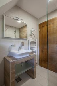 a bathroom with a sink and a mirror at Rooms Imperial House in Plitvička Jezera