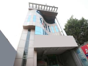 a building with a white sign in front of it at Hotel Arneja in Jalandhar