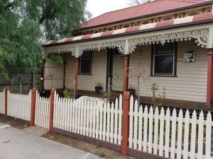 a white picket fence in front of a house at Myers CBD in Bendigo