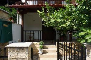 a house with a black gate and a tree at Magnolia in Agios Nikolaos