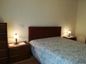 a bedroom with a bed and two night stands at Casa Serra da Lapa in Viseu