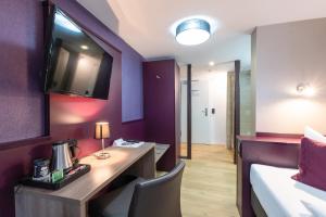 Postel nebo postele na pokoji v ubytování Hotel Porta Nigra