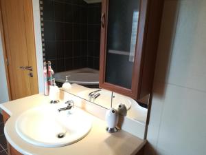 a bathroom with a sink and a mirror at Casa Serra da Lapa in Viseu +29 photos