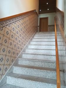 a set of stairs in a building with tiles at Casa Serra da Lapa in Viseu