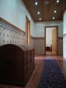 a room with a fireplace and a hallway with a door at Casa Serra da Lapa in Viseu