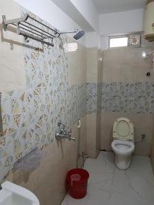 a bathroom with a toilet and a sink at Jimmy Guest House in Kolkata