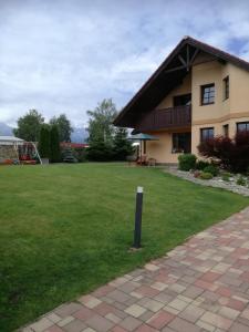 a house with a green lawn in front of it at Vila Štefan Drevko in Poprad +10 photos