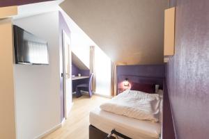 Postel nebo postele na pokoji v ubytování Hotel Porta Nigra