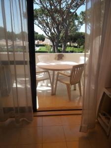 a cat sitting on a table on a patio at A Apartmento Solar dos Pinheiros in Vilamoura