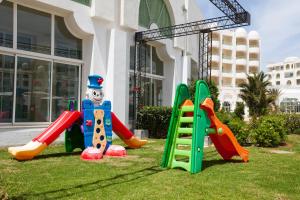 a group of playground equipment in front of a building at El Mouradi El Menzah in Hammamet