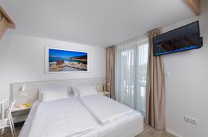 Postel nebo postele na pokoji v ubytování Zlatni Zalaz,Apartments,Supetarska Draga
