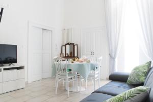 a white living room with a table and chairs at Casa Bianca in Giovinazzo