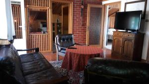 a living room with a couch and a table and a television at Mica in Senj