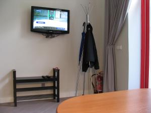 a room with a tv on the corner of a wall at Studio 59 in Kaunas