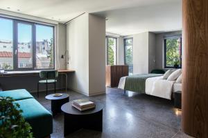 A bed or beds in a room at Perianth Hotel