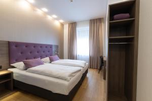 Postel nebo postele na pokoji v ubytování Hotel Porta Nigra