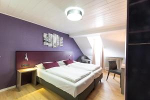 Postel nebo postele na pokoji v ubytování Hotel Porta Nigra
