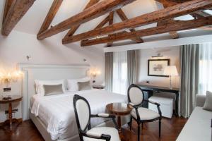 1 dormitorio con 1 cama, escritorio y sillas en Hotel Casa Verardo Residenza d'Epoca, en Venecia