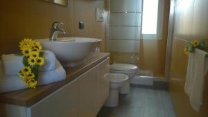 a bathroom with a sink and a toilet at House Orizzonte - Casa Bianca in Genoa
