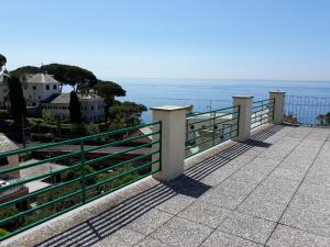 a balcony with a view of the ocean at House Orizzonte - Casa Bianca in Genoa