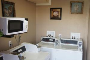 a room with a microwave and two computer monitors at Days Inn by Wyndham Victorville in Victorville