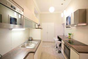 a kitchen with a sink, stove, and refrigerator at Prague Center Apartments in Prague