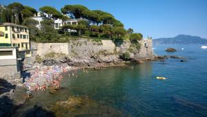 a group of people in the water at a beach at House Orizzonte - Casa Bianca in Genoa