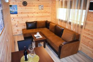 a living room with a couch and a table with wine glasses at Saranda Beach Bungalow in Ulcinj