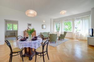 a dining room and living room with a table and chairs at Nosislav Apartments in Nosislav