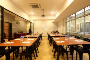 a dining room with wooden tables and chairs at SK Homestay Selayang in Batu Caves