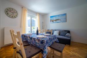 a living room with a table and a couch at Apartments Raspolic in Kastav