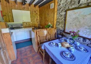 a kitchen with a table with a blue table cloth at Ochr y Foel in Trefriw