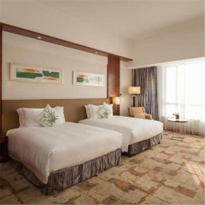 Cinese Hotel Dongguan Shijie tesisinde bir odada yatak veya yataklar